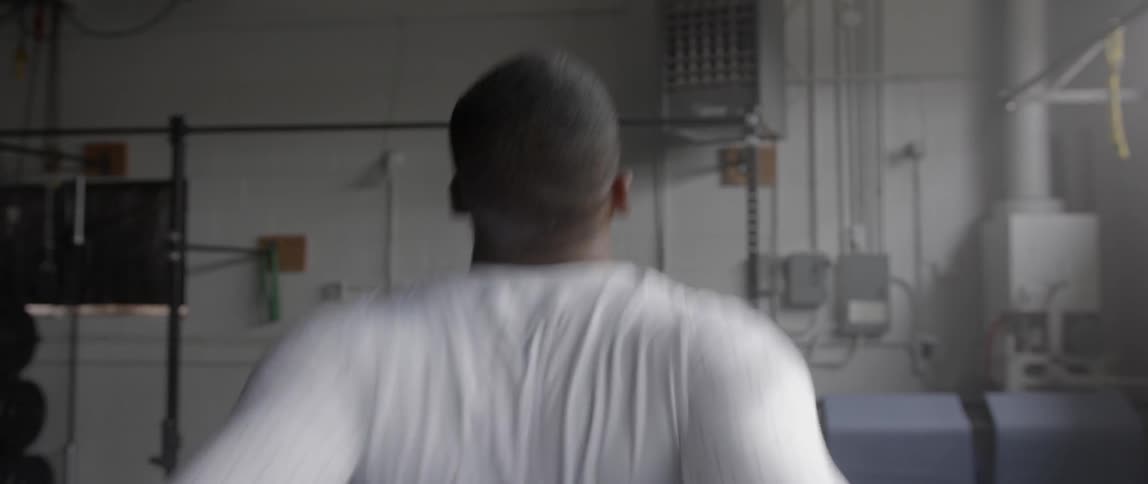 A man stretches and warms up in a gym