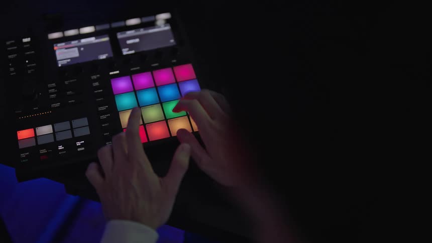 Man in studio creates music using a groove production system