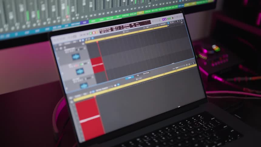 Laptop monitor shows audio graph according to control panel displayed on another monitor