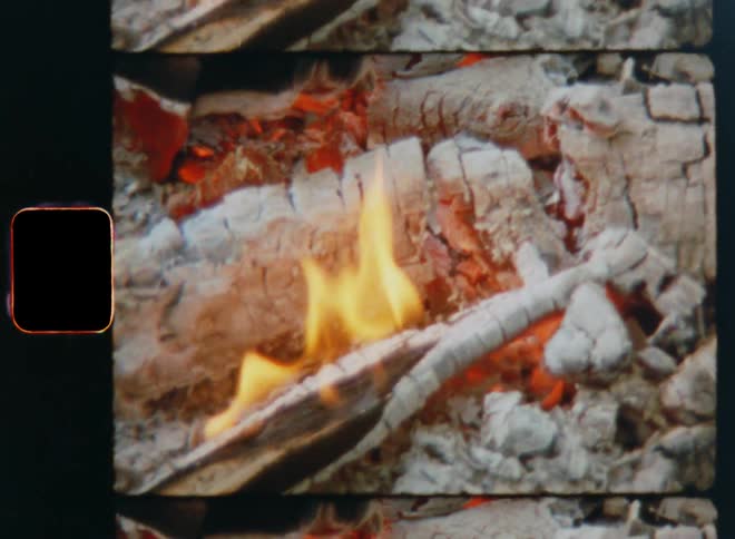 Flames grow taller as a pile of wood burns