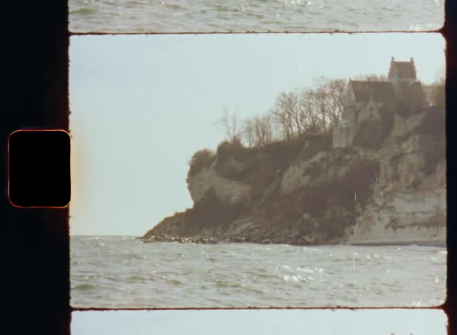 A home sits on a cliff over the sea