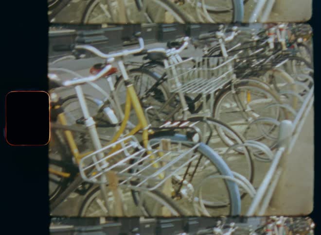 A row of bikes are parked on the rack