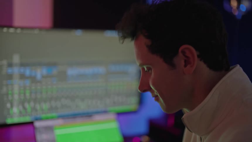 A man is making music on his computer