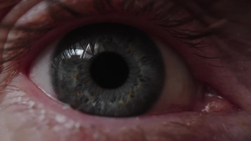 A close up of someone opening their eye