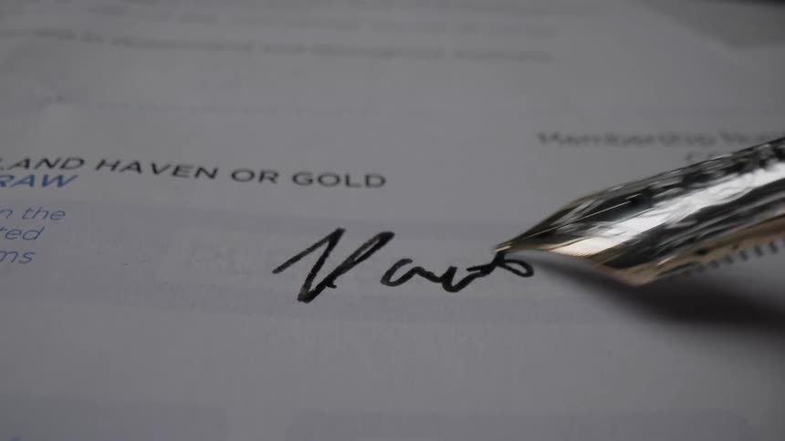 A person signs a piece of paper