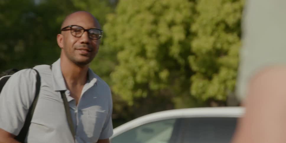 One friend continues smoking as another friend takes leave and walks away
