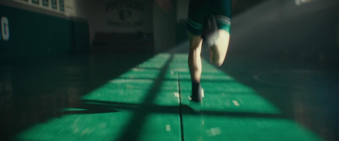 A teenager is running in the gym