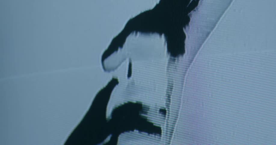 An image of hands is on the fuzzy monitor