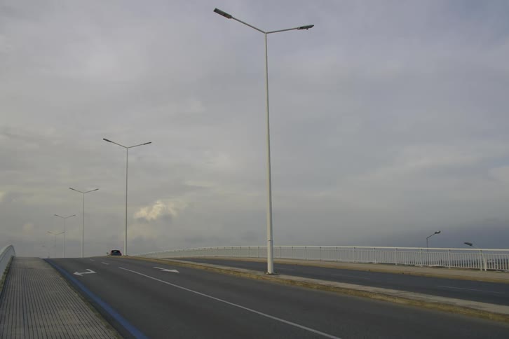 Car driving along a highway on a cloudy day