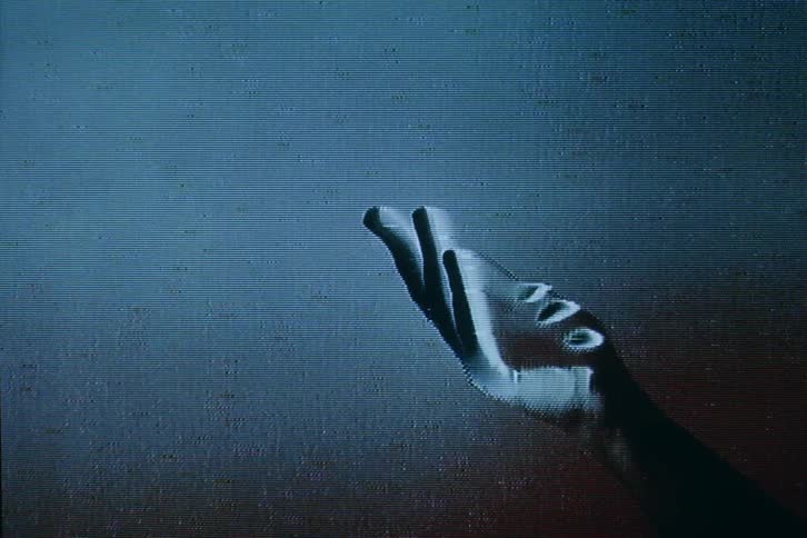 Staticky signal distorts hand of person