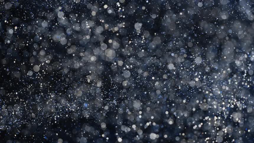 Multiple layers of spots flow against black background