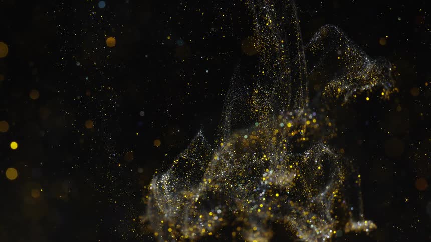 White and yellow glitter flows through white and yellow spotted black background