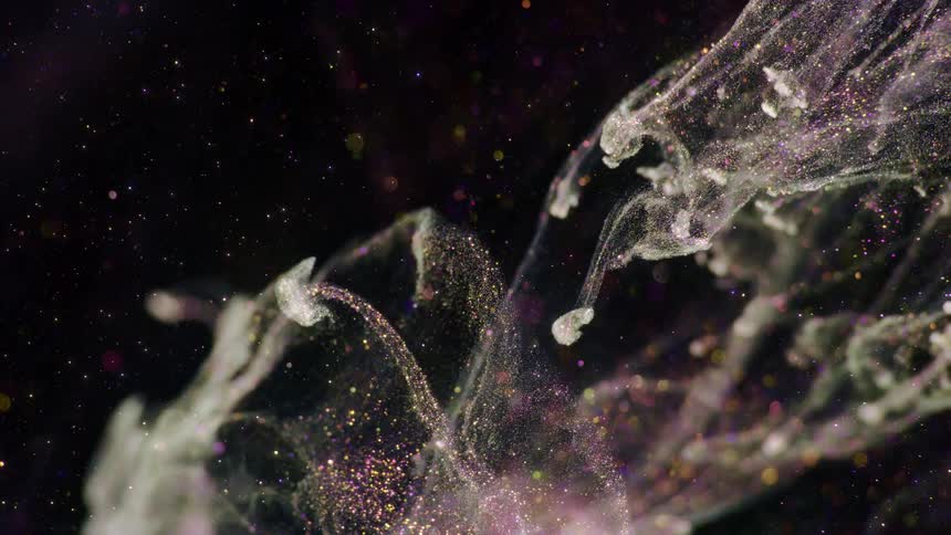 iridescent sparkles shoot in a cloud in open space