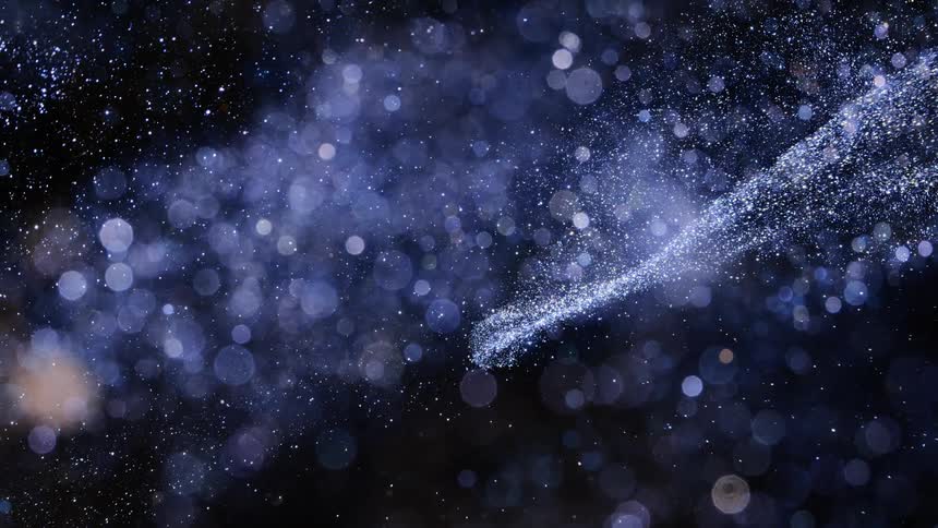 The blue and sparkling dust moves around like a nebula in deep space