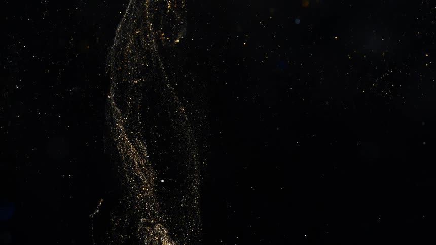 Pale cloud of glowing crystalline particles flow across dark background