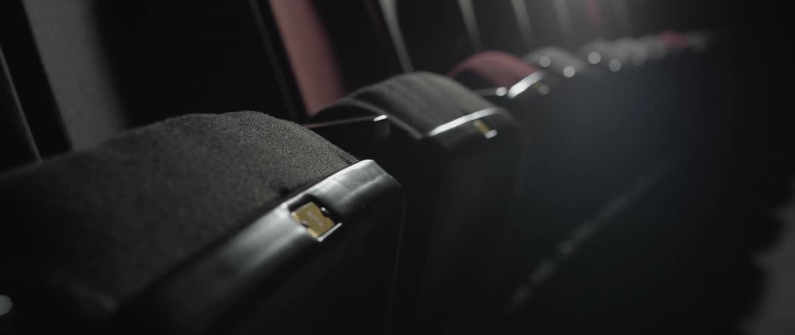 A row of empty movie theater seats