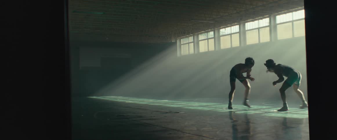 Two men are wrestling in the gym