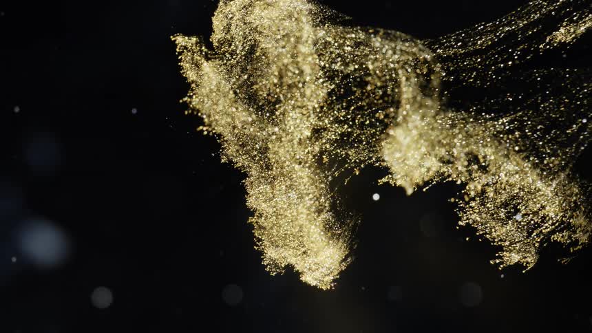 Glowing crystalline particles fly through darkness with scattered light spots