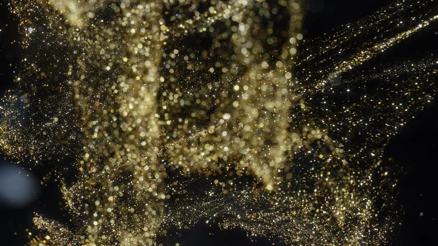 Golden particles fly across black expanding and creating light spots