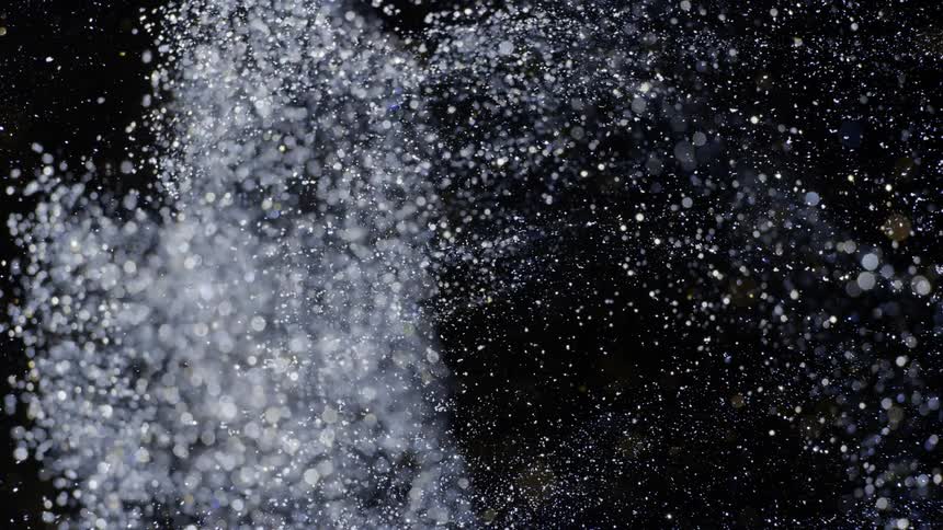 The sparkling dust shoots away like a cloud of glass particles