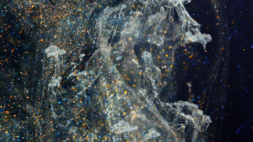 liquids paint and glitter moving up in a fishtank