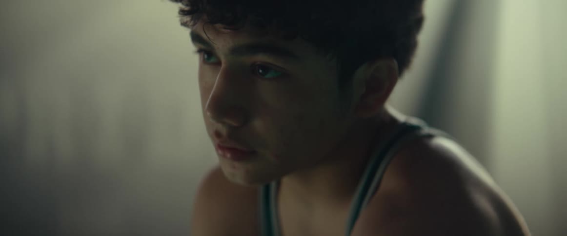 A teenager is sitting in the dark room
