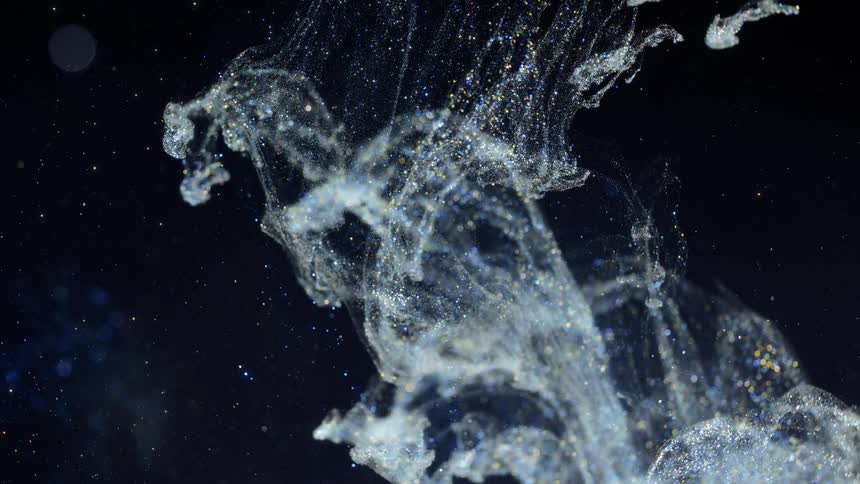 Glittering fluid splashes downward against black background