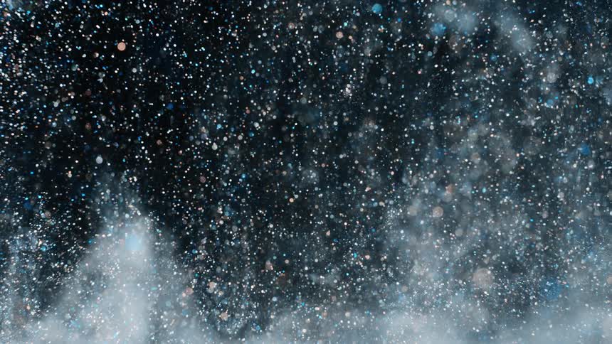 Crystalline particles fall thickly through dark creating iridescent light spots before entering white wispy clouds