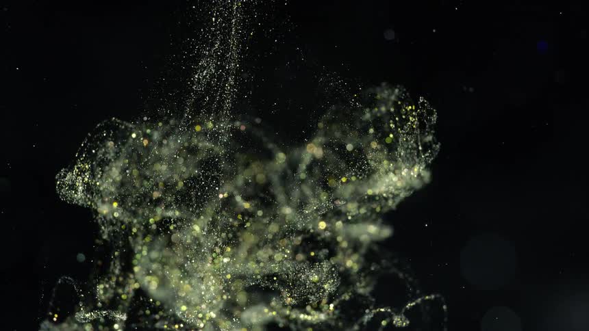 Green and white sparkes falling down in slow motion