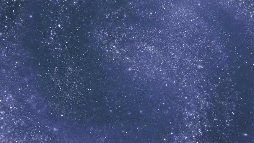 White glinting particles swirl against a dark background