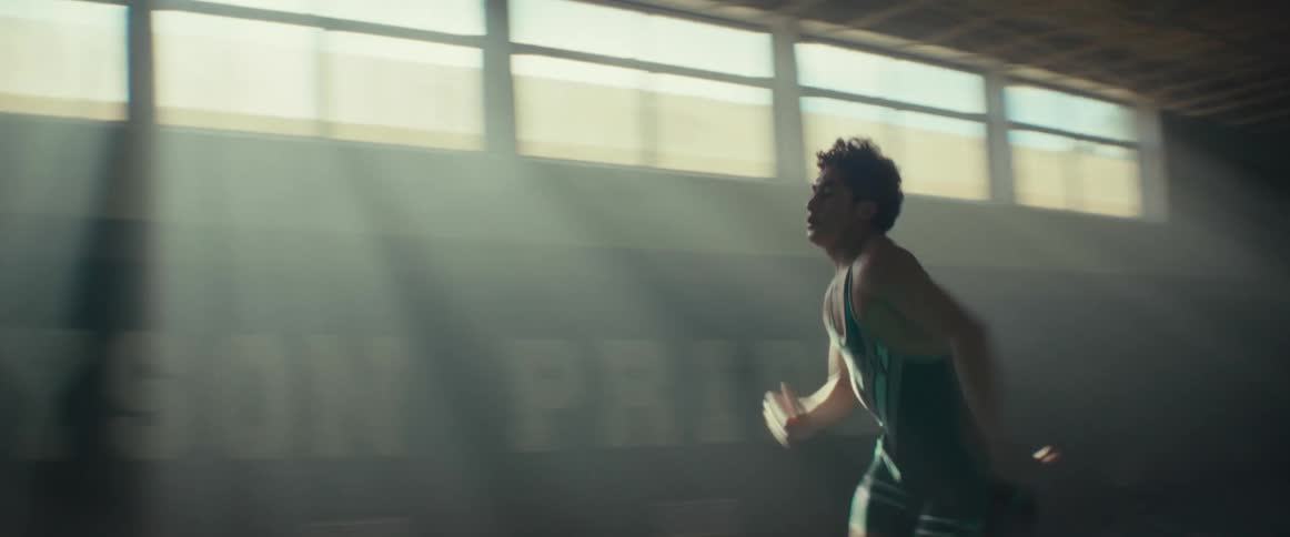 A teenager races across the gym
