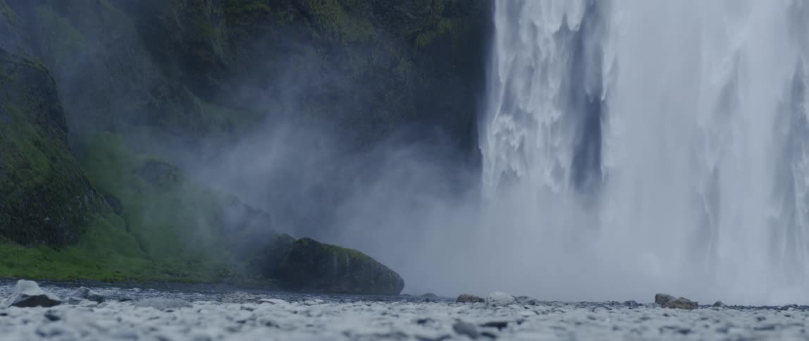 Water splashes down from the cliff