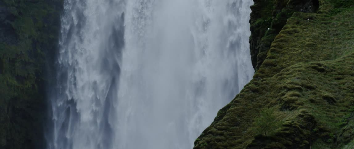 A waterfall flows over a cliff