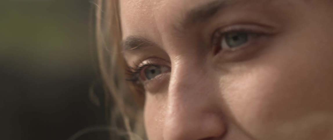 A woman's hair blows around her face