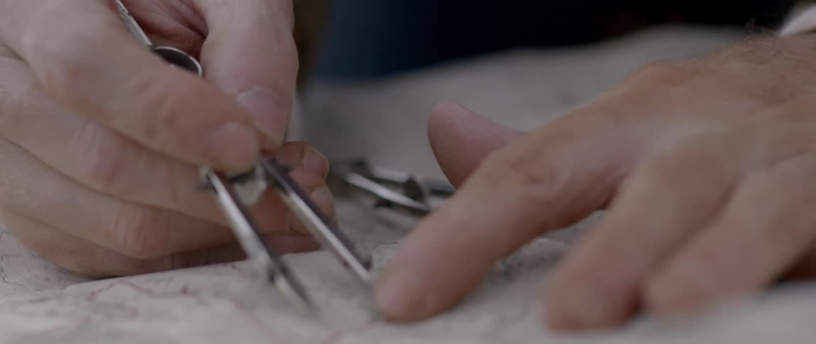 Man pointing something at the map using some tools