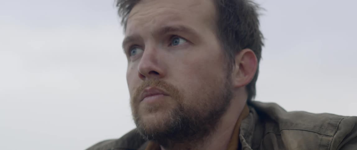 A man in a leather jacket outdoors during the day