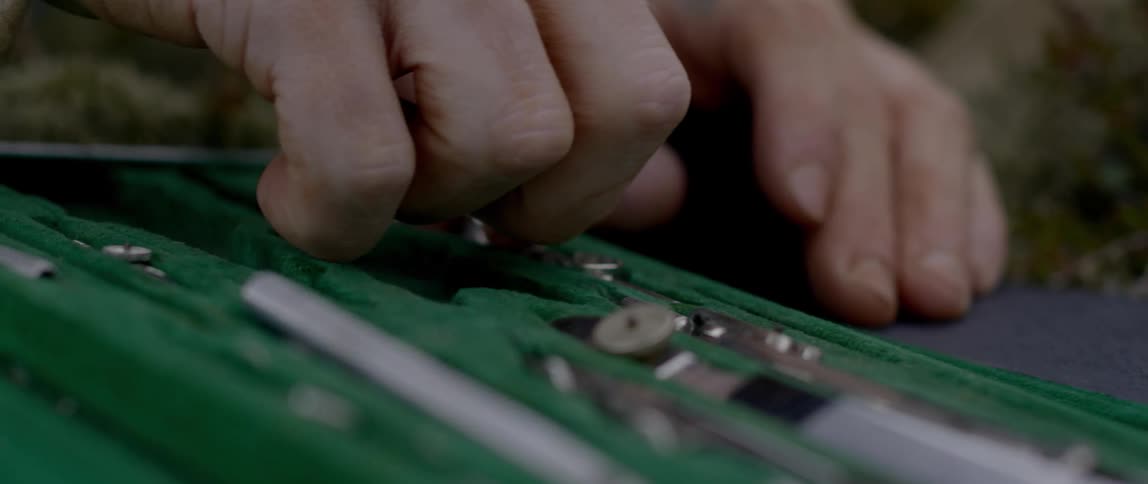 Person selects metal tool from case