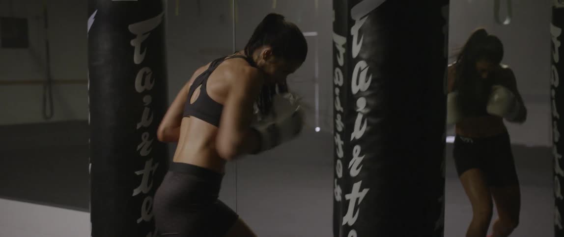 A woman is punching a bag