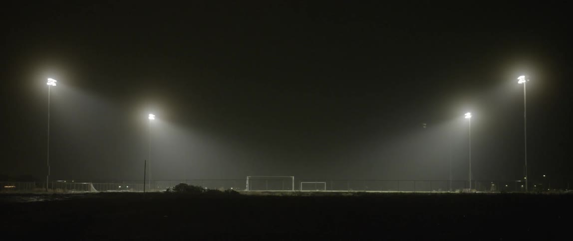 A field has some spotlights on at night