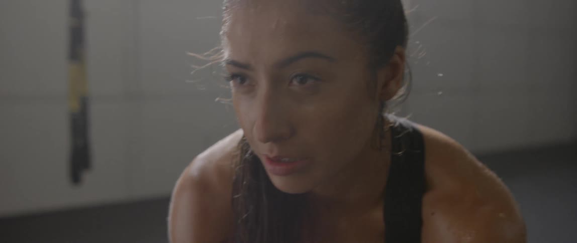 A woman looks up breathing heavy