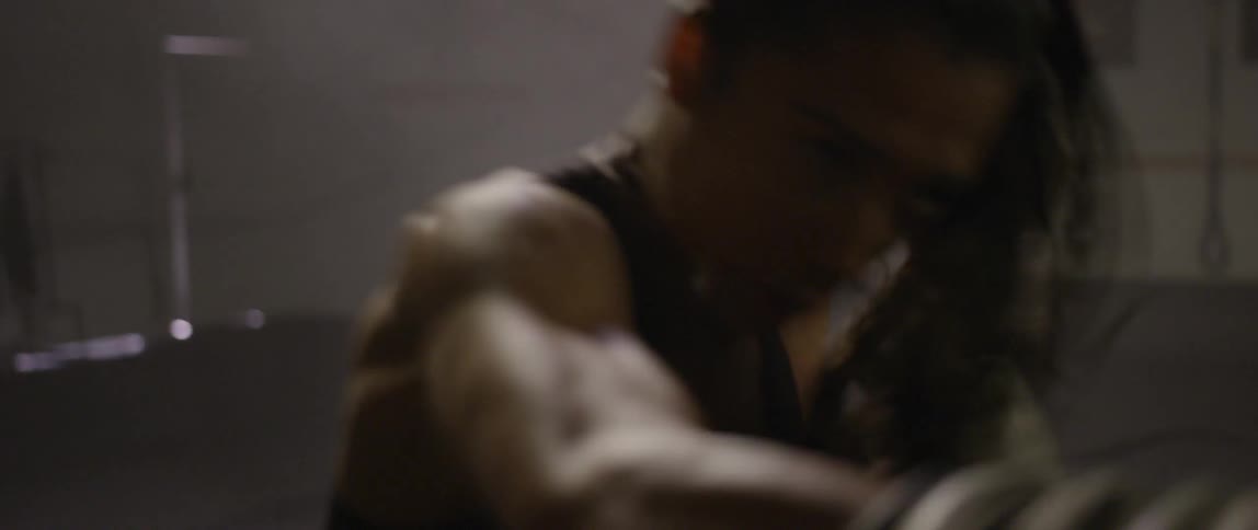 A woman is practicing on a punching bag