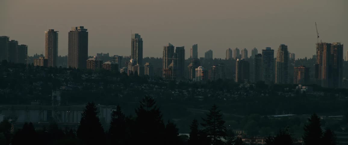 A still shot of a downtown city skyline and skyscrapers at dusk
