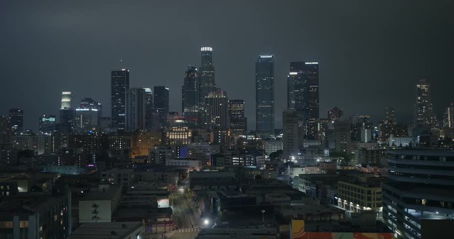 Skyscrapers loom over a metropolis at night