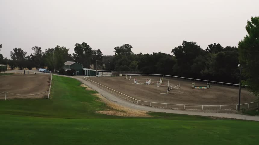 An obstacle course for horses in process of being assembled on a farm