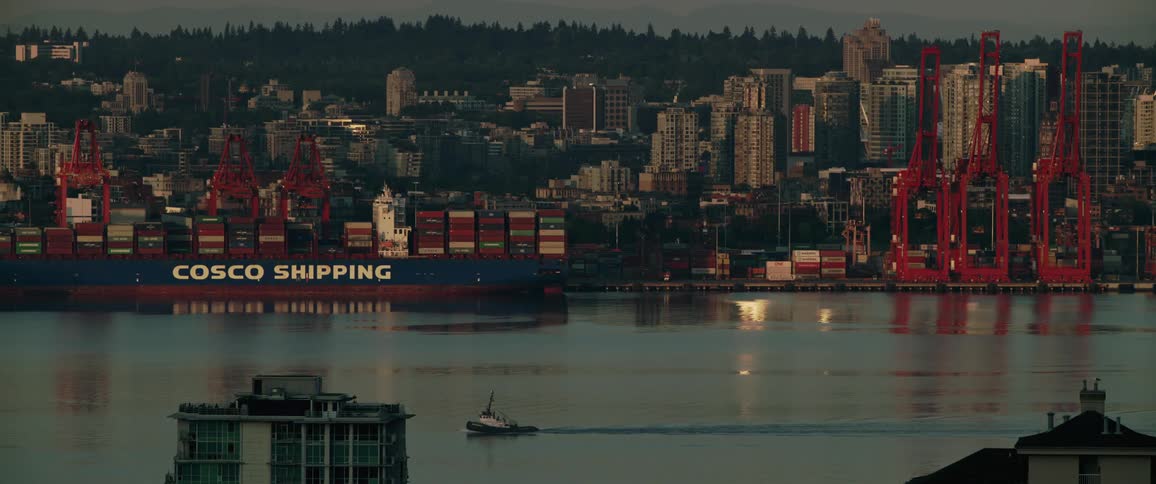 Cargo ship in the port near the city