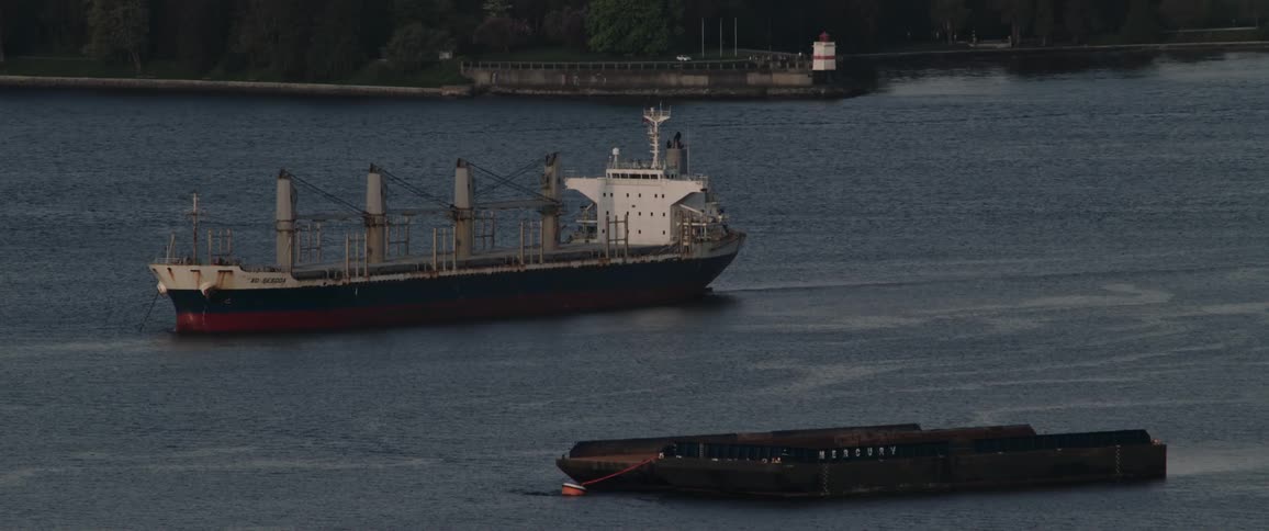 A ship is moving in ocean water during midday