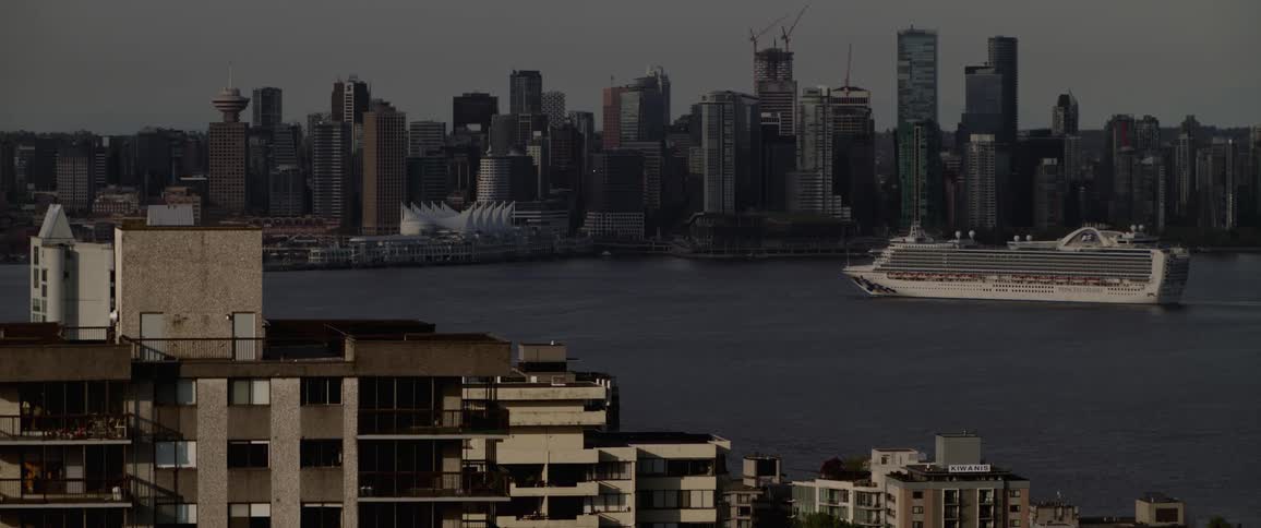 Cruise ship crossing a river in front of the city