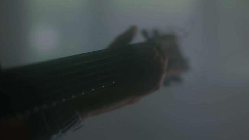 A person holding and playing the guitar strings