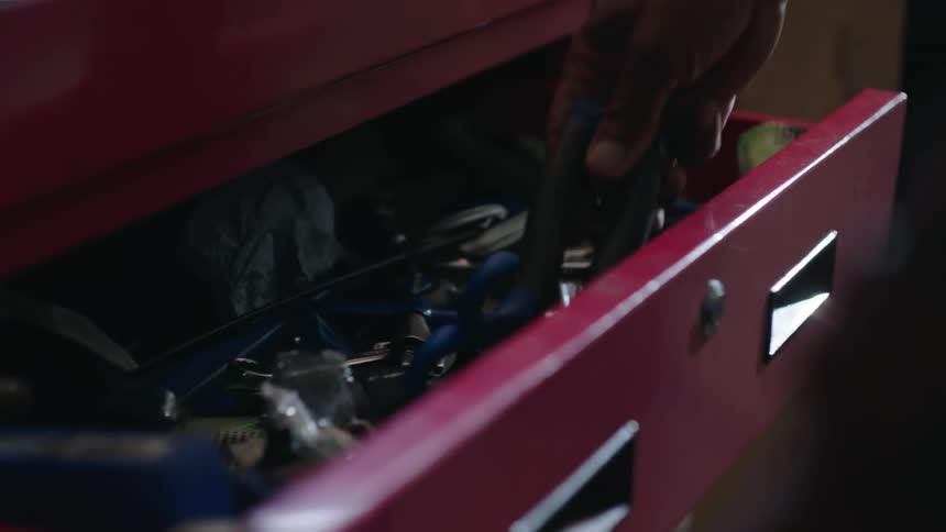 A person puts the tool on the rack
