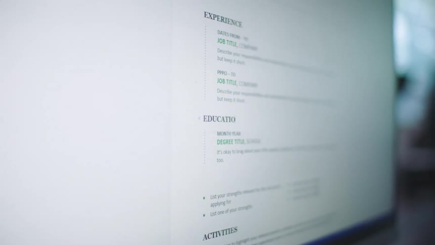 Someone is typing a resume on a computer screen
